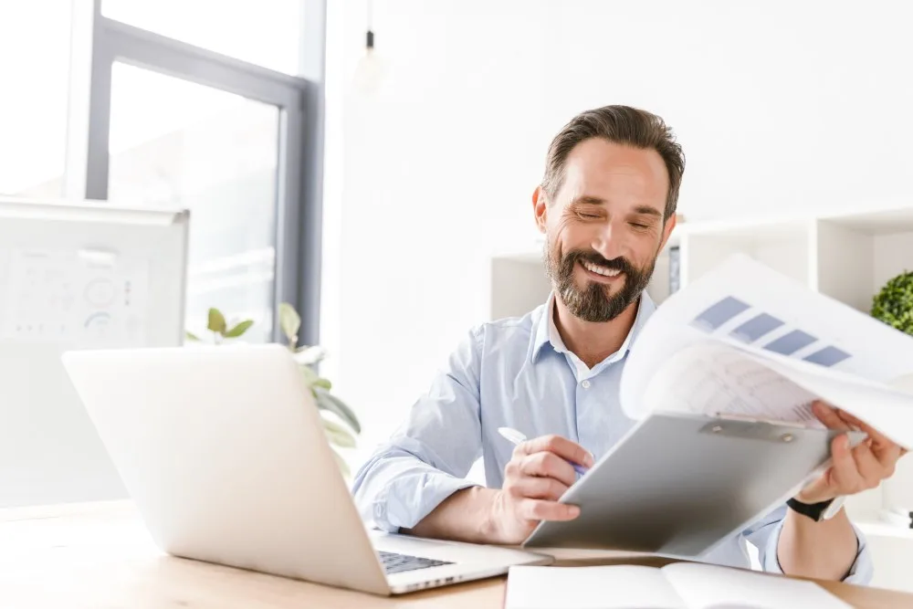 Happy Businessman Holding Folder